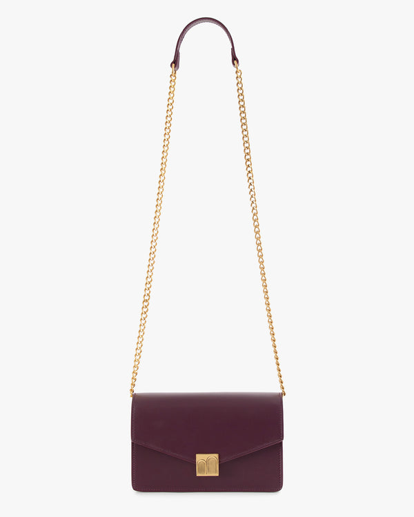 ELEANOR bag in Aubergine, laid flat with gold chain extended, Marble Arch clasp visible