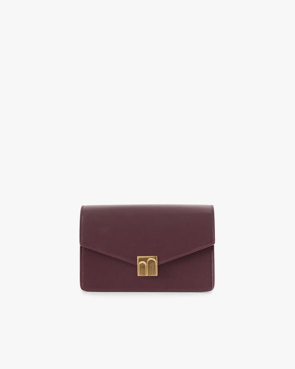 ELEANOR bag in Aubergine, front view, gold Marble Arch clasp, standing