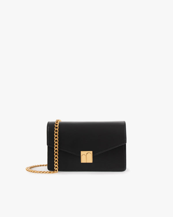 ELEANOR bag in black leather, front view, closed flap, gold Marble Arch clasp, removable chain strap