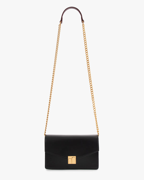 ELEANOR bag in black, front view, gold Marble Arch clasp, detachable chain with burgundy shoulder strap