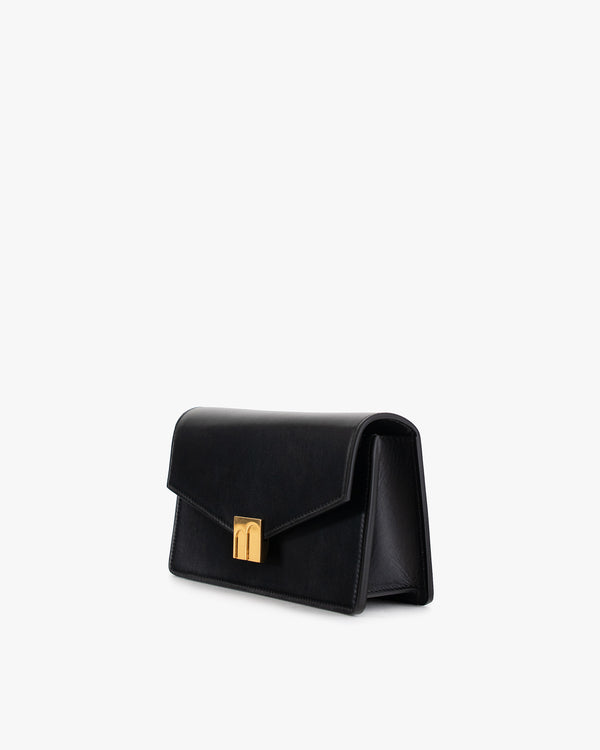 ELEANOR bag in black leather, three-quarter view, standing, gold Marble Arch clasp visible
