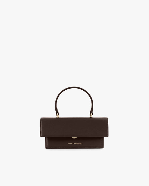 THEA MINI bag in chocolate, front view, standing, with flap and top handle