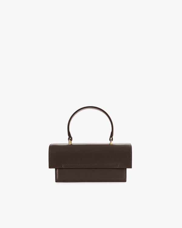 THEA MINI bag in chocolate, front view, standing, with rounded handle and oversized flap