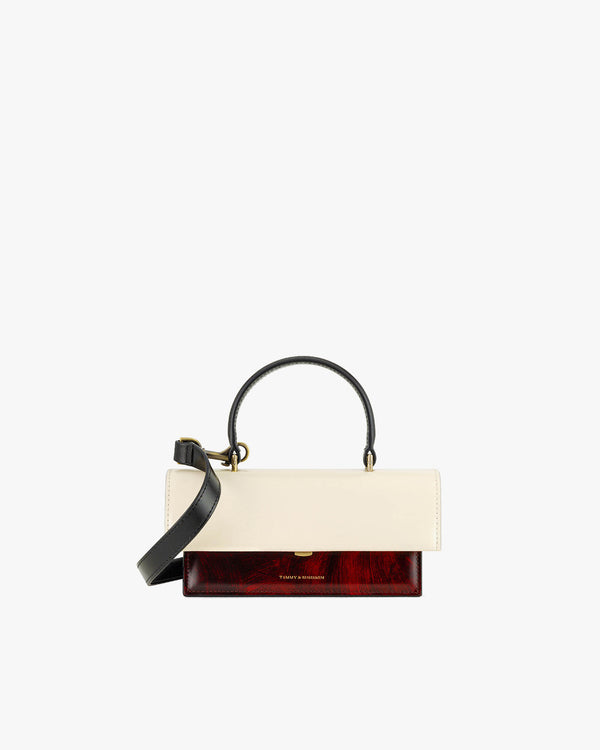 Sac THEA MINI colourblock art déco, vue de face, rabat ivoire et base rouge veiné, anse noire