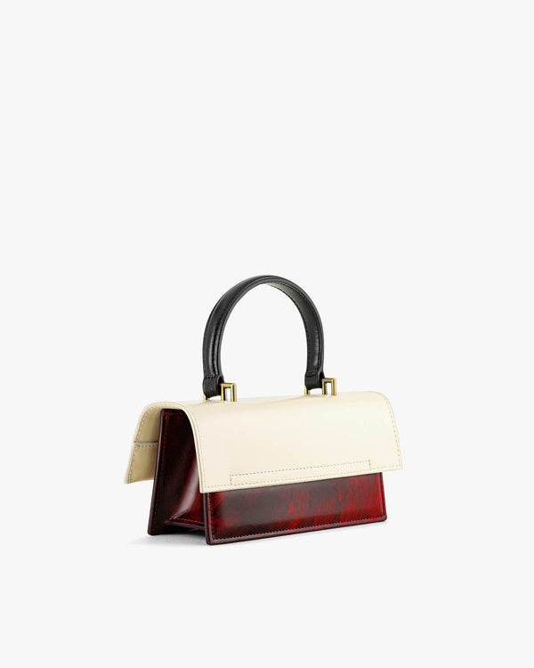 Sac THEA MINI colourblock art déco, vue de trois quarts, poignée noire, rabat ivoire et corps bordeaux