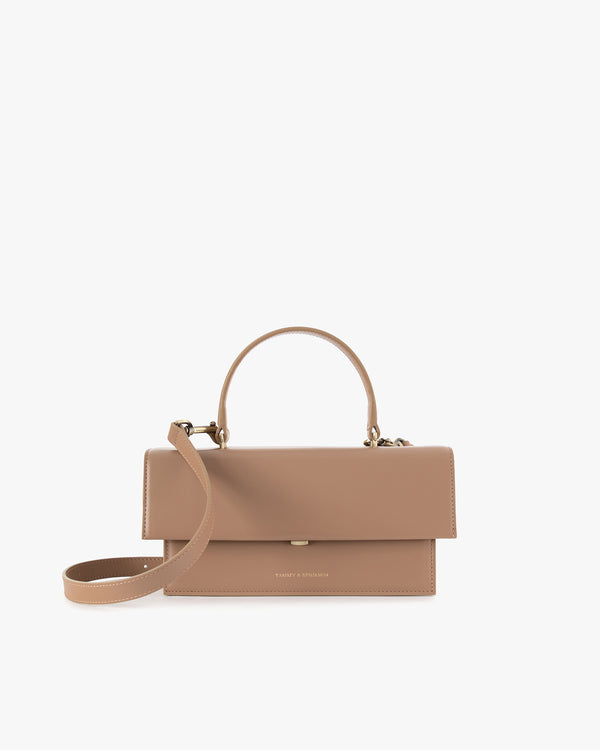 THEA bag in beige, front view, closed flap with top handle and adjustable strap