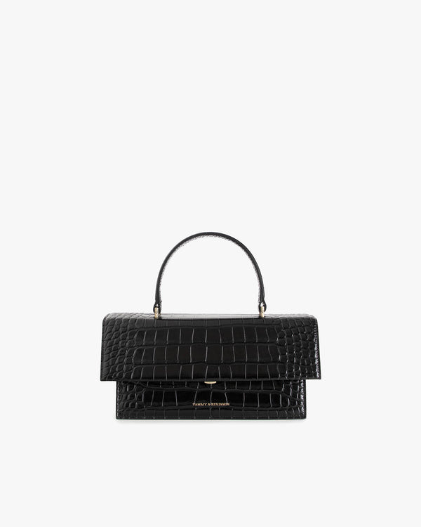 Sac THEA noir embossé crocodile, vue de face, posé, avec poignée rigide