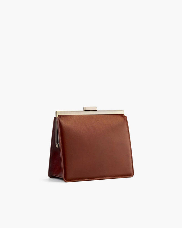 JEANNE bag in brown, side view, showing gold metal clasp and structured silhouette