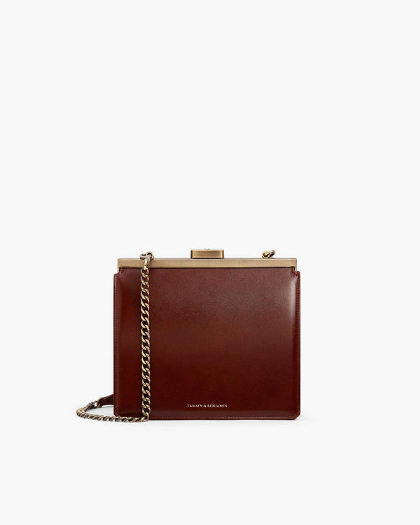 JEANNE bag in brown, front view, gold clasp, removable chain strap, on white background