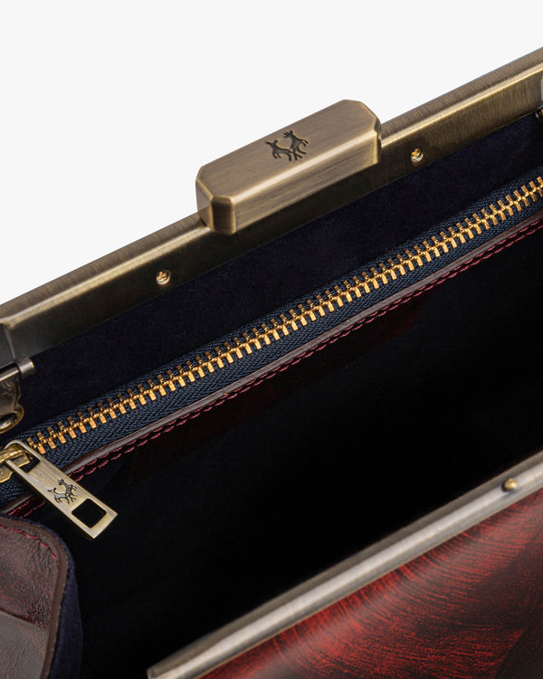 JEANNE bag in Marbre, open view showing the metal clasp and interior zip pocket