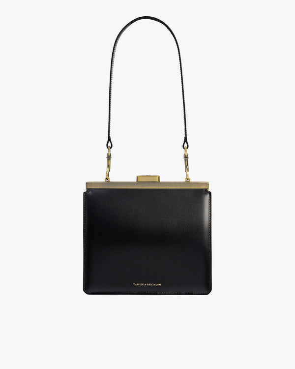JEANNE bag in black leather, front view with gold metal clasp and detachable shoulder strap