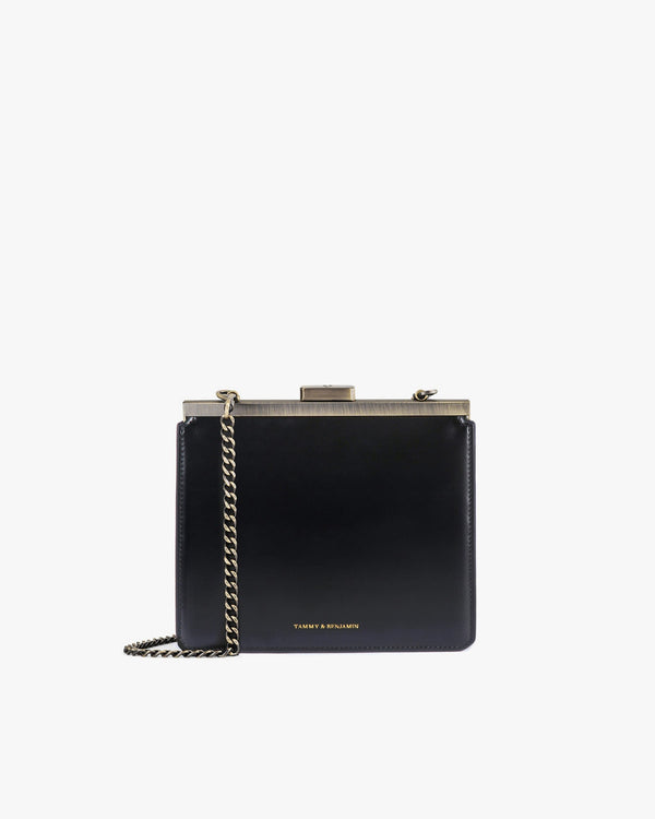 JEANNE bag in black, front view, gold-tone metal clasp, detachable chain worn crossbody